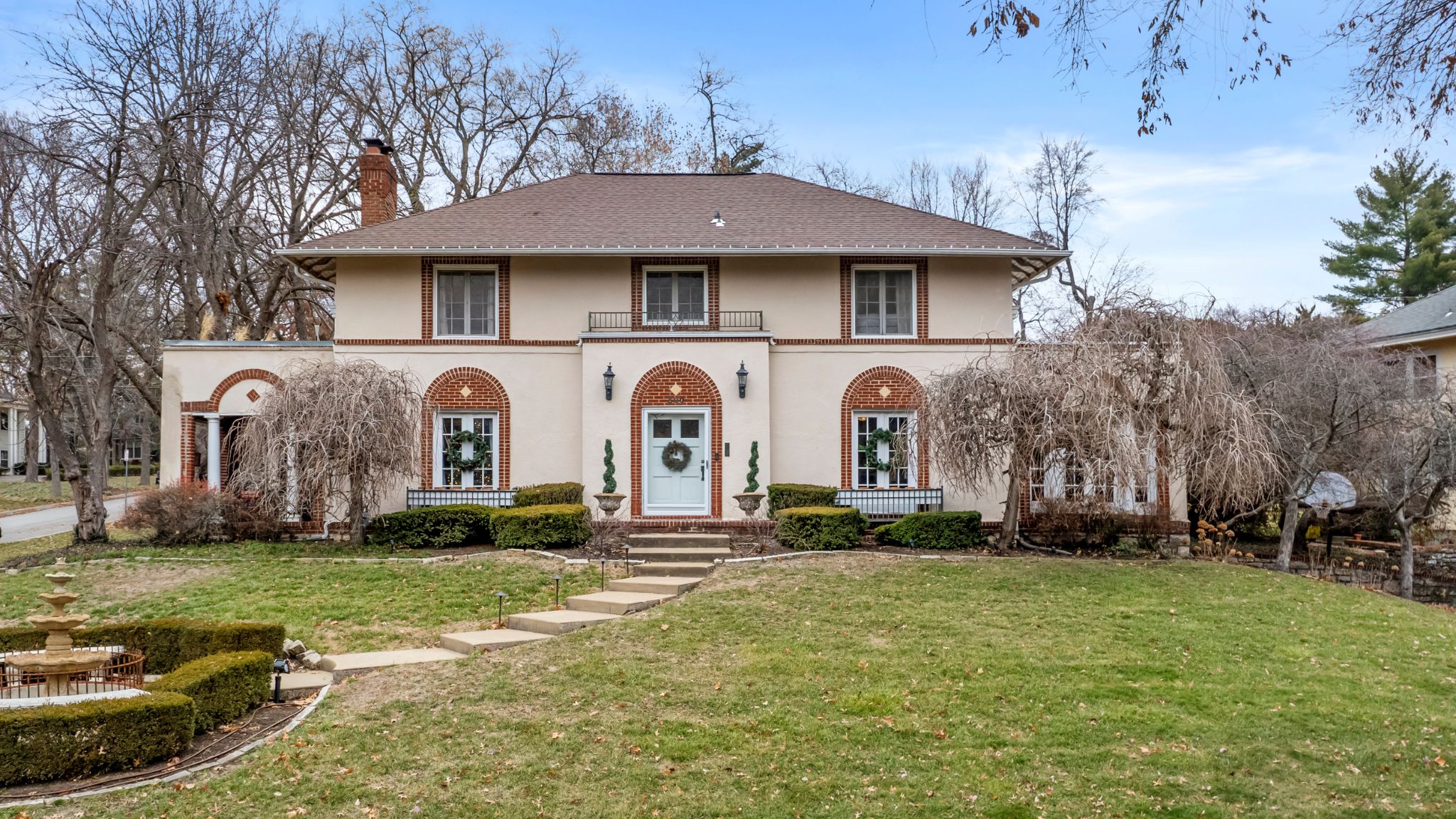 Front photo of a historic home on an elevated corner lot.
