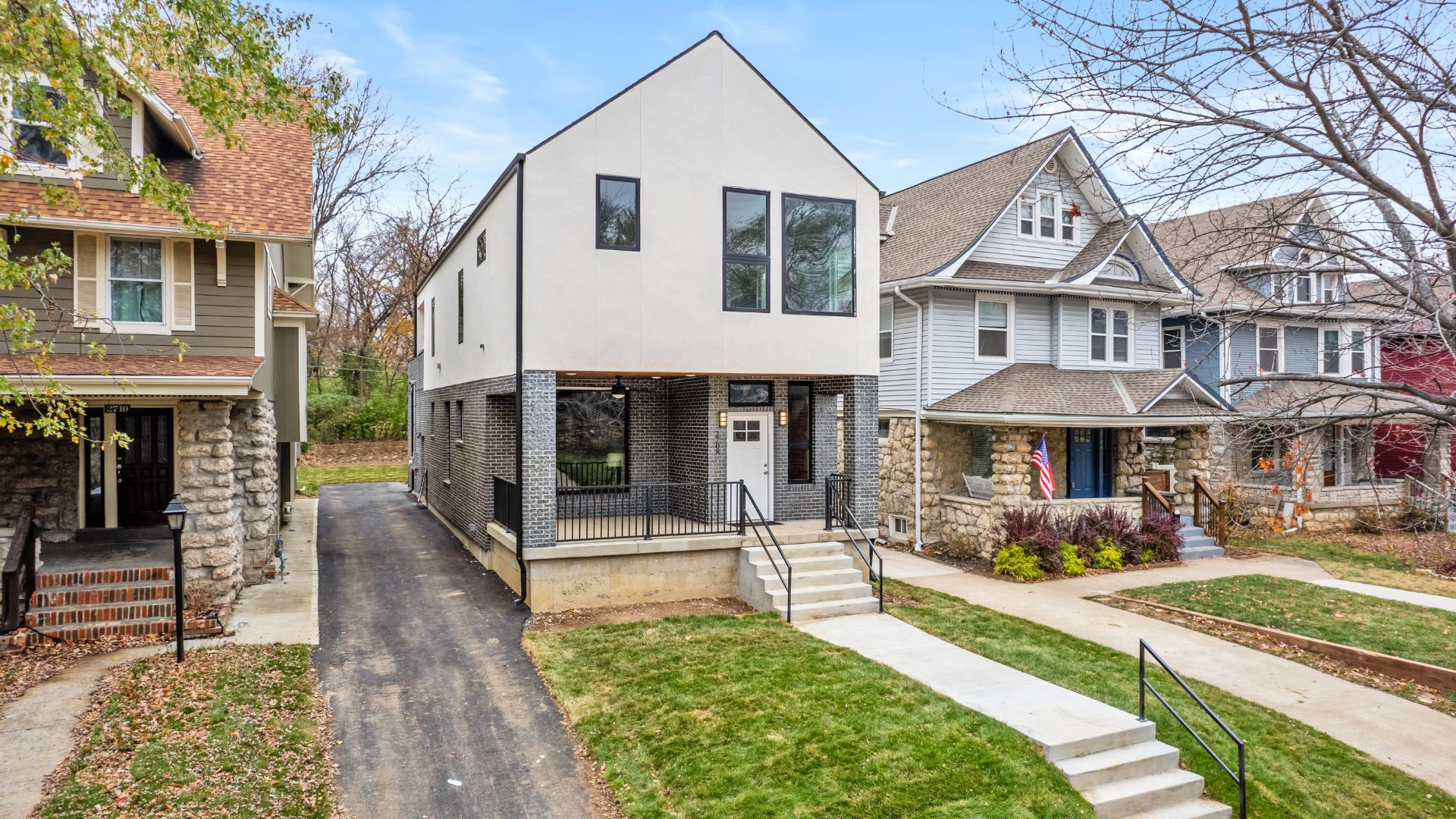 Front shot of a modern newly built home wth long pathway.