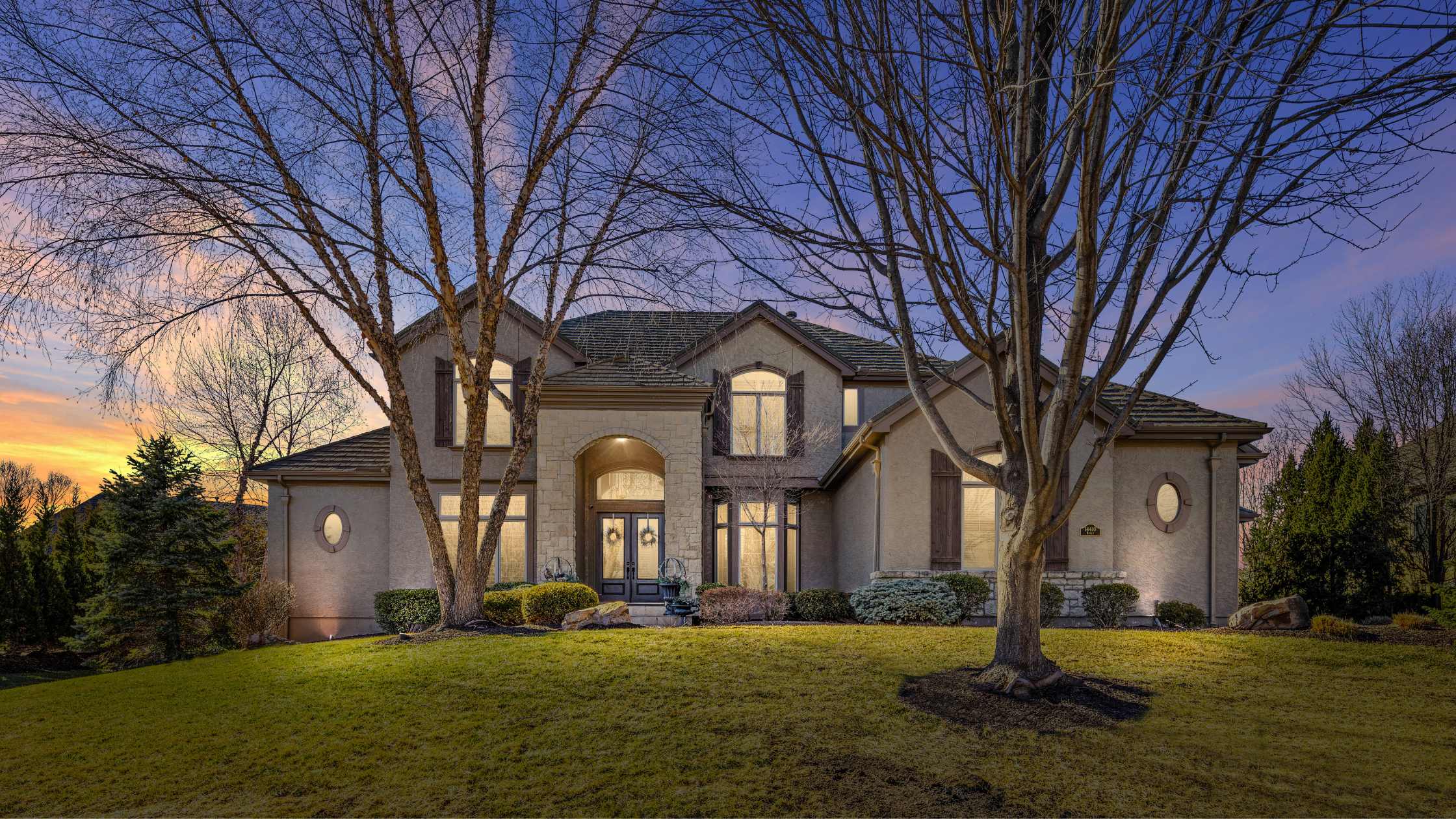 Exterior twilight photo of a stone home.
