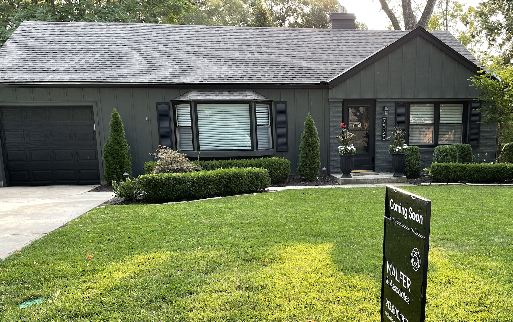 Home with for sale sign in yard